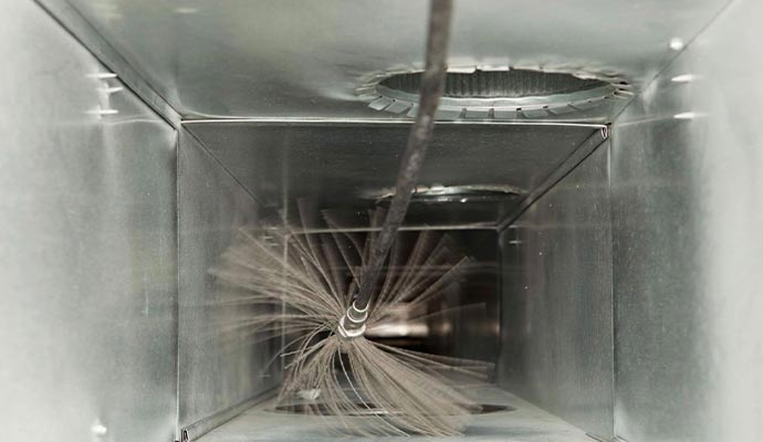 Internal air duct cleaning process with rotating brush