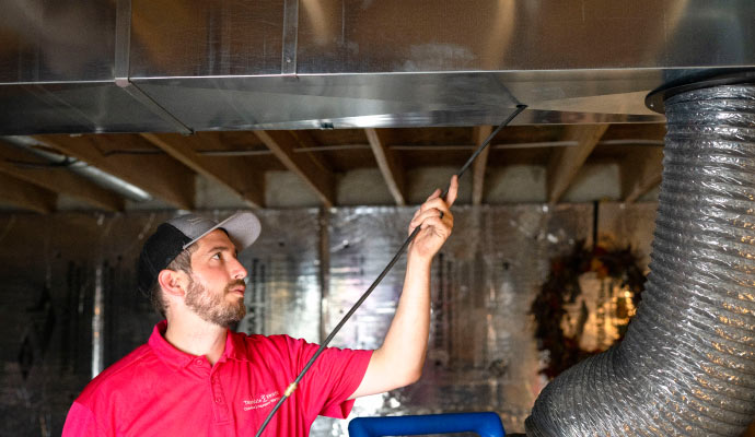 Professional worker cleaning duct