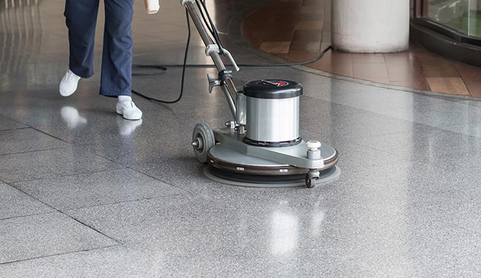 Professional person cleaning the floor using equipment