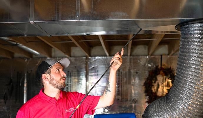 Professional worker cleaning duct