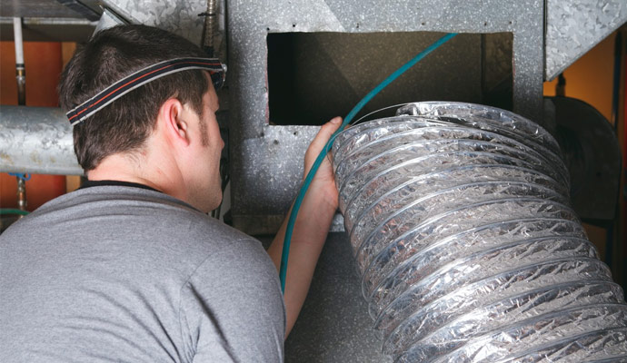 Professional worker cleaning duct system