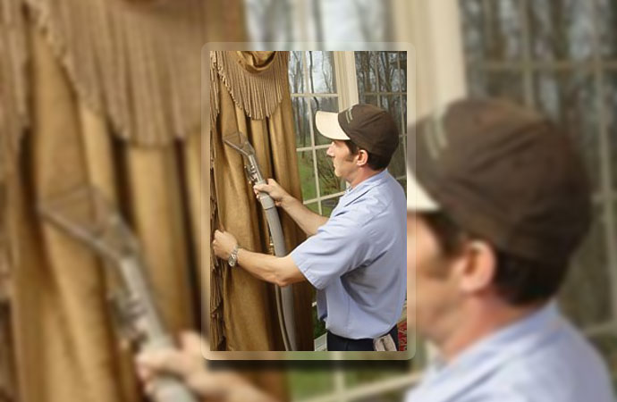 Professional worker cleaning drapery